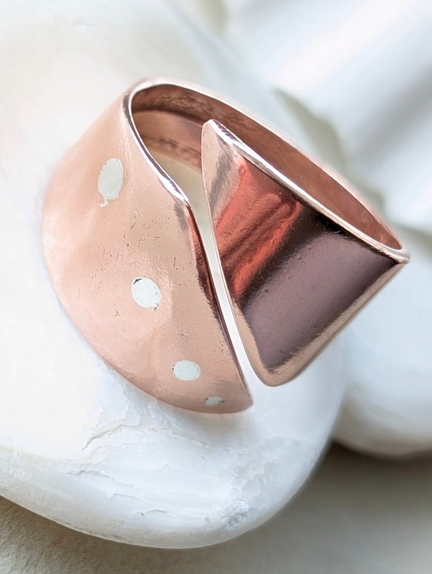 Reclaimed copper ring on a white marble surface