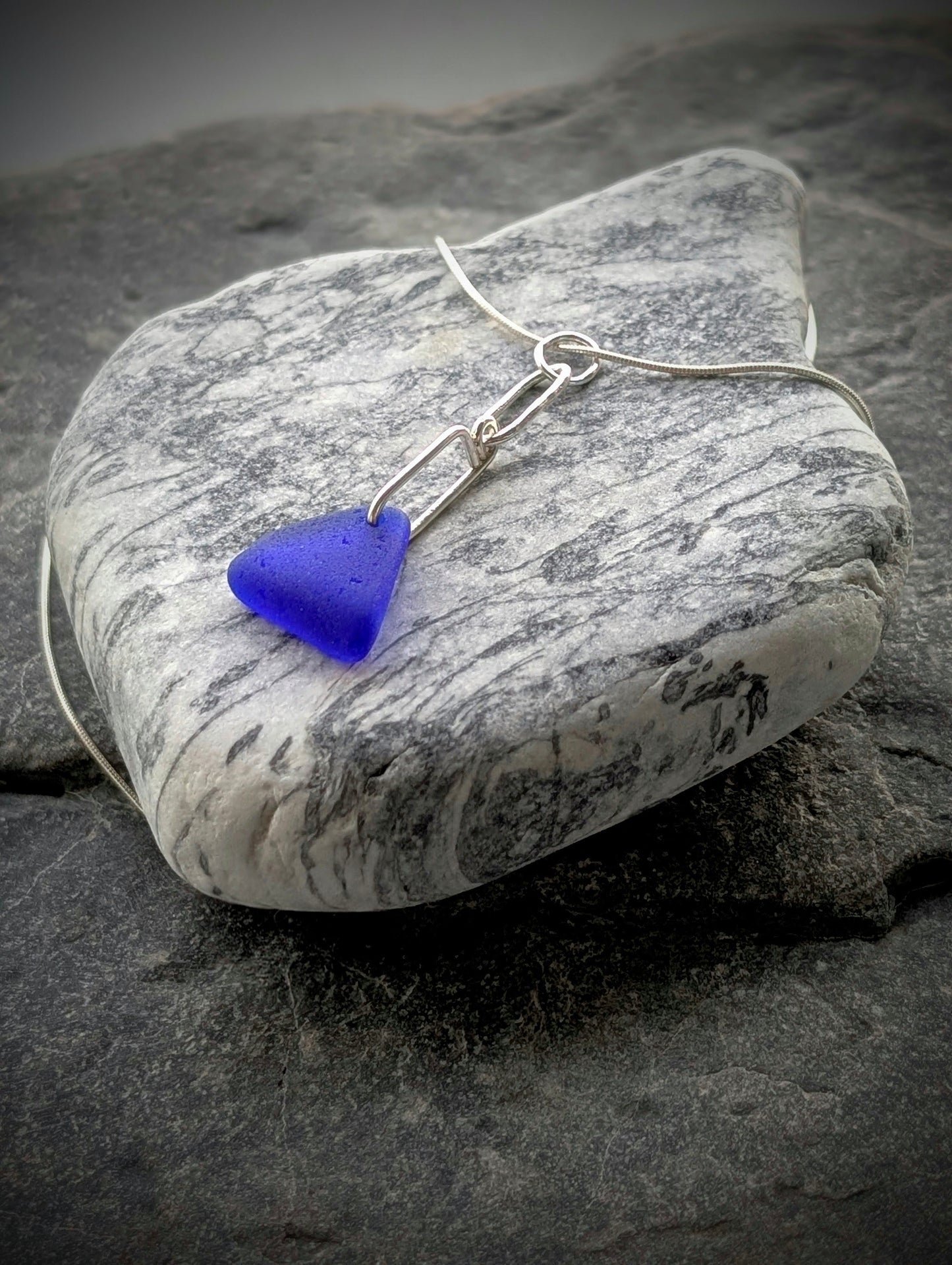 Blue Sea Glass Triangle on Hand-shaped Sterling Silver Wire