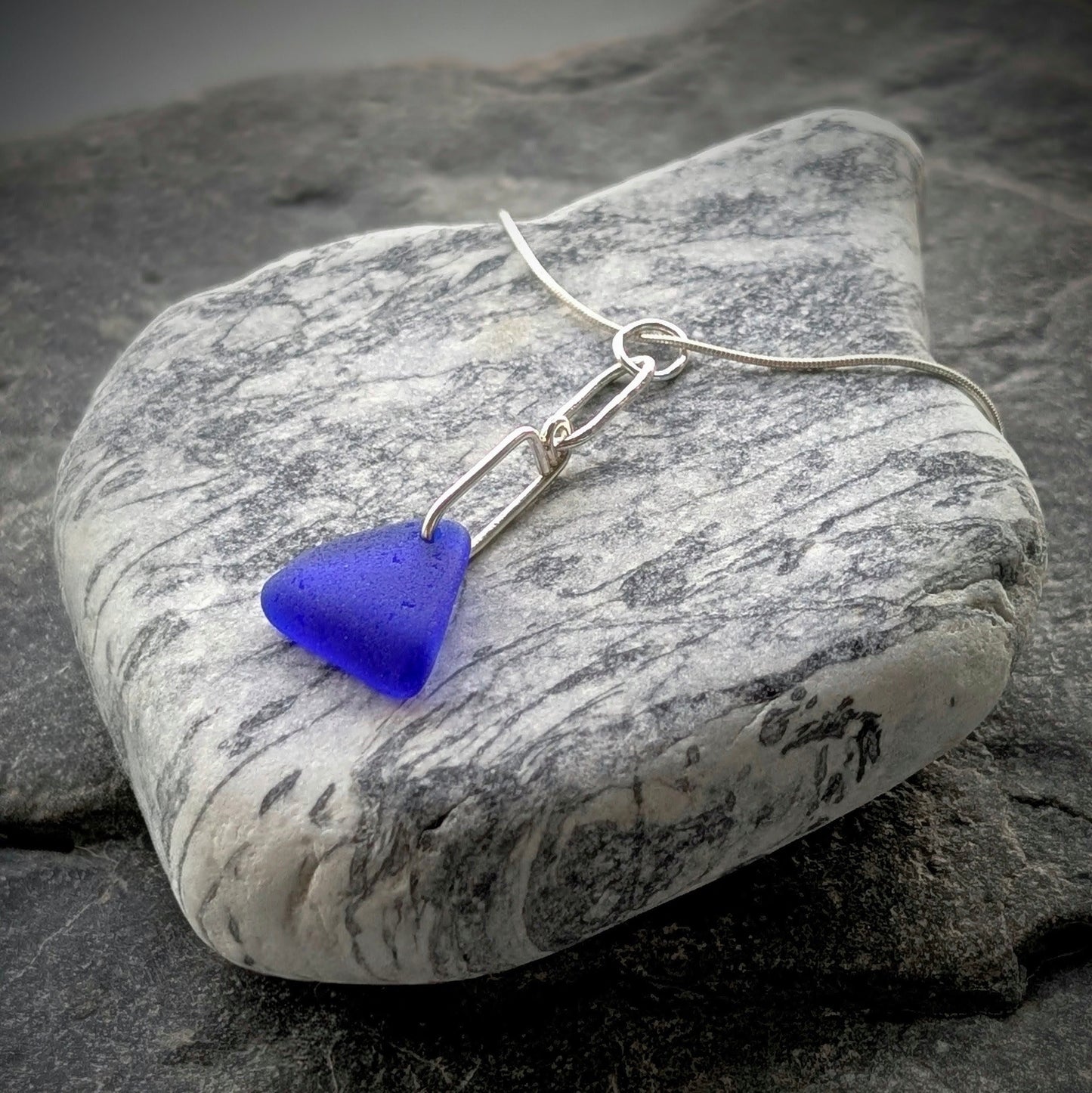 Blue Sea Glass Triangle on Hand-shaped Sterling Silver Wire
